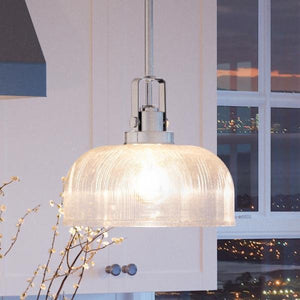 An Urban Ambiance Harlow Collection pendant, a luxury lighting fixture, hanging over a kitchen island.