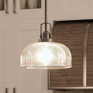 A unique and stylish lighting fixture, the UHP2051 Industrial Chic Pendant from the Harlow Collection by Urban Ambiance elegantly hangs over a kitchen counter.