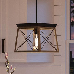 An UHP2124 Industrial Chic Pendant, 9"H x 10"W, Olde Bronze Finish from the Berkeley Collection by Urban Ambiance hanging over a kitchen counter in a unique and beautiful way