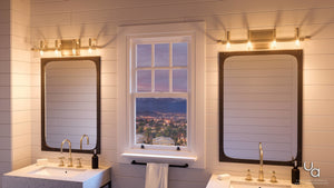 Modern bathroom with two sinks and rectangular mirrors, illuminated by the Urban Ambiance UHP2135 Contemporary Bathroom Vanity Light from the Sevilla Collection in a sleek brushed bronze finish (6.38″H x 30″W), featuring a central window revealing a cityscape and mountains at sunset.