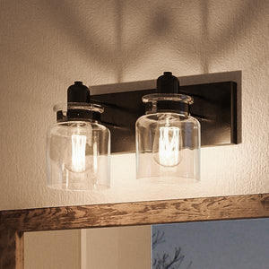 Two gorgeous jar lights hanging above a mirror in a bathroom.