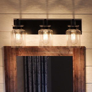 An Urban Ambiance bathroom mirror with a gorgeous wooden frame and two luxurious jar lights.