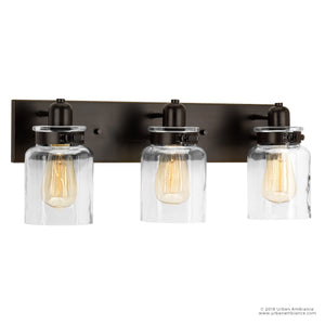 The UHP2143 Modern Farmhouse Industrial Bath Fixture from Urban Ambiance’s Bridgeport Collection features three vintage-style bulbs in clear glass jars, elegantly mounted on a rectangular base with an Olde Bronze finish. Measuring 8-5/8″ high by 21-5/8″ wide, this stylish fixture brings modern industrial charm to your bath décor.