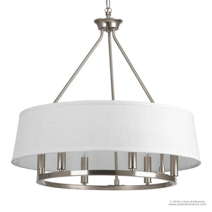 The Urban Ambiance UHP2182 Cosmopolitan Chandelier from the Marsala Collection features a modern transitional design with a white drum shade, brushed nickel finish, and multiple bulbs. Measuring 22.375 inches high by 24 inches wide, it is suspended by three metal rods and a chain.