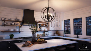 A gorgeous kitchen with unique white cabinets and black counter tops, featuring the UHP2210 Vintage Chandelier from Urban Ambiance's Anchorage Collection.