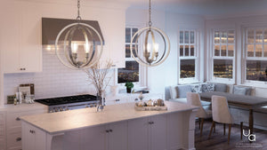 Modern kitchen featuring white cabinets, a marble island, stainless steel stove, and a dining nook with city views through expansive windows. Two UHP2213 Vintage Chandeliers from Urban Ambiance’s Anchorage Collection, with a galvanized steel finish (24″H x 21-1/4″W), provide vintage-inspired lighting that enhances the contemporary design.