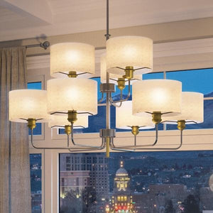 A luxury lighting fixture - Cosmopolitan Chandelier, by Urban Ambiance - with a view of a city.