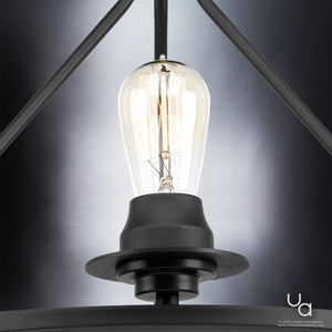 Close-up of the Urban Ambiance UHP2241 Luxe Industrial Ceiling Fixture from the Nashville Collection, featuring a lit Edison-style bulb in a charcoal-finished black metal frame, photographed against a gradient gray background to perfectly capture its industrial chic aesthetic.