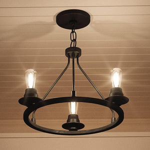 The UHP2241 Luxe Industrial Ceiling Fixture by Urban Ambiance, featuring a charcoal finish and measuring 15″H x 19-7/8″W from the Nashville Collection, hangs from a chain on a white paneled ceiling with three vintage-style bulbs, casting warm light for an industrial chic look.
