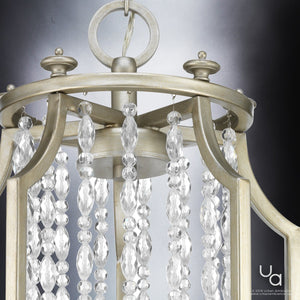 Close-up of the Urban Ambiance UHP2252 Mediterranean Chandelier from the Lexington Collection, featuring an antique silver finish and hanging crystal strands, set against a gradient gray background.