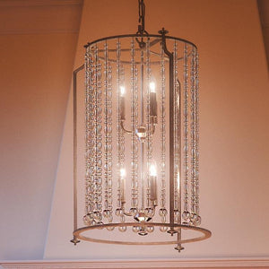 An Urban Ambiance UHP2256 Traditional Chandelier featuring crystals hanging from it, adding an exquisite touch to any space.