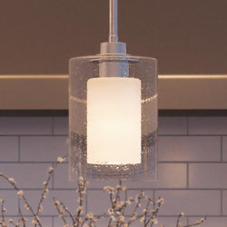 A beautiful Urban Ambiance UHP2260 Contemporary Pendant Light, 10"H x 5.875"W, Polished Chrome Finish from the Memphis Collection hanging over a kitchen counter.