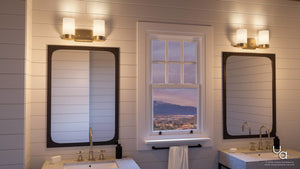 Bathroom with two sinks, two mirrors, and open-frame Madison Collection lighting from Urban Ambiance (UHP2291 Contemporary Bathroom Vanity Light, 7.5″H x 15.375″W, Brushed Bronze Finish) featuring vintage-inspired bulbs above each mirror. A window in the center provides a stunning mountain view, while a white towel hangs neatly on a bar below the window.