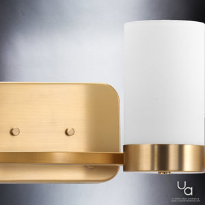 Close-up of the Urban Ambiance UHP2295 Contemporary Bathroom Vanity Light from the Madison Collection, featuring a brushed bronze rectangular base and a cylindrical white glass shade against a gray background—an elegant 7.5″ high by 34.5″ wide fixture ideal for stylish bath spaces.