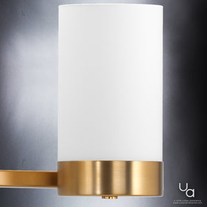 The UHP2295 Contemporary Bathroom Vanity Light by Urban Ambiance features a sleek cylindrical white shade and a brushed bronze metal base, mounted on a minimalist metallic arm. Part of the Madison Collection and measuring 7.5″ high by 34.5″ wide, this modern fixture is perfect for adding contemporary style and illumination to your bath or hallway décor.