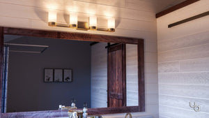 A modern bathroom with a large mirror, wooden sliding door, and the Urban Ambiance UHP2295 Contemporary Bathroom Vanity Light from the Madison Collection in brushed bronze, mounted above the mirror.