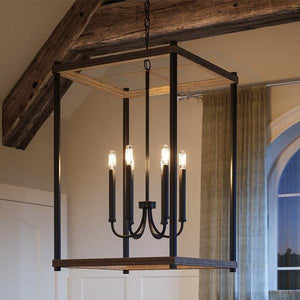 A luxury UHP2380 Modern Farmhouse Narrow Chandelier fills a room with wooden beams.