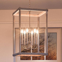 A beautiful Urban Ambiance UHP2383 Modern Farmhouse Narrow Chandelier, 25"H x 14"W, Brushed Nickel Finish, Leeds Collection hanging over a window in a gorgeous room.