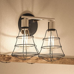 Two luxury Urban Ambiance UHP2420 Vintage Bathroom Vanity Lights, 11"H x 15.625"W, Charcoal Finish, Syracuse Collection, hanging on a wooden wall.