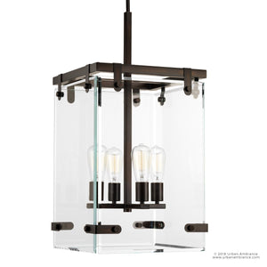 The Urban Ambiance UHP2442 Modern Chandelier from the Bristol Collection features a rectangular glass design with four exposed bulbs and a black metal frame in an Olde Bronze finish, suspended from a straight rod. With its 28-3/8″ height and 14-3/4″ square profile, this fixture brings elegant modern farmhouse charm to your space—perfect for those who appreciate the stylish simplicity of a cube ceiling light.