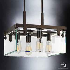 The UHP2448 Modern Farmhouse Ceiling Fixture by Urban Ambiance features a rectangular design with beveled glass accents and four exposed Edison-style bulbs, suspended by two black cables against a gray background. This 14″H x 16-3/4″W SQ ceiling light from the Bristol Collection showcases an Olde Bronze finish, evoking timeless elegance reminiscent of classic pendant fixtures.