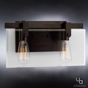 The Urban Ambiance UHP2452 Modern Farmhouse Bath Fixture from the Bristol Collection features an Olde Bronze finish, a dark metal frame, and two exposed Edison bulbs mounted on a white rectangular background; shown here in a front view. Fixture dimensions: 8-3/8″ high by 14-7/8″ wide.