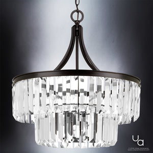 The UHP2462 Traditional Chandelier from the Lille Collection by Urban Ambiance features an Olde Bronze finish and showcases multiple tiers of hanging prismatic glass crystal prisms, elegantly illuminated against a gray background. Measuring 23-7/8″ high by 22-1/4″ wide, this striking handcrafted fixture seamlessly blends elegance and sophistication, making it a standout addition to any contemporary space.