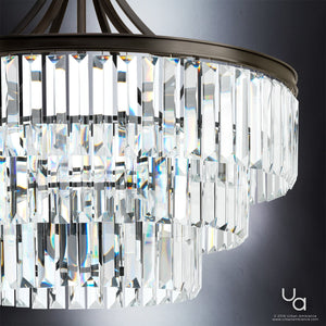 Close-up of the Urban Ambiance UHP2464 Traditional Chandelier from the Lille Collection, featuring three tiers of rectangular glass prisms suspended from an Olde Bronze-finished frame and beautifully reflecting light; measures 29-1/4″ high by 28″ wide.