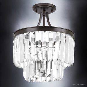 The Urban Ambiance UHP2467 Cosmopolitan Ceiling Light from the Lille Collection features an Olde Bronze finish and showcases two tiers of clear, rectangular prismatic glass prisms, beautifully illuminated against a gradient gray background.