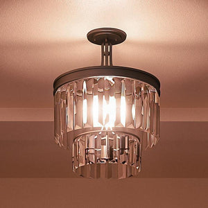 The Urban Ambiance UHP2467 Cosmopolitan Ceiling Light from the Lille Collection features an Olde Bronze finish and showcases two tiers of hanging prismatic glass prisms, creating a beautifully illuminated effect and casting soft light on the ceiling. Measuring 15-1/2″ x 13-1/8″, this fixture is both elegant and functional.