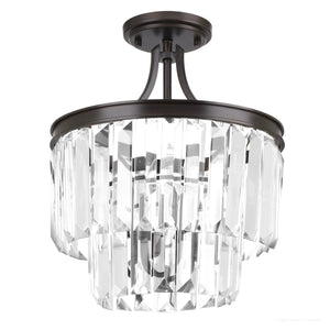 The UHP2467 Cosmopolitan Ceiling Light from Urban Ambiance’s Lille Collection features an Olde Bronze finish and a dark metal frame, with two tiers of clear prismatic glass rectangular crystal prisms. Measuring 15-1/2″ x 13-1/8″, this semi-flush mount ceiling light offers sophisticated style.