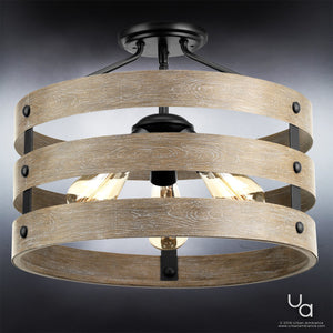 The Urban Ambiance UHP2470 Modern Farmhouse Flush-Mount Ceiling Fixture from the Adelaide Collection features three exposed bulbs surrounded by two horizontal wooden rings and charcoal steel cage accents, all mounted on a dark base. The fixture measures 13-1/2″ high by 17″ wide and comes in a charcoal finish.
