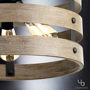 Close-up of the UHP2470 Modern Farmhouse Flush-Mount Ceiling Fixture from the Adelaide Collection by Urban Ambiance. The 13-1/2″H x 17″W light features drum-inspired wooden rings, exposed bulbs, a charcoal rustic finish, and black metal accents—blending rustic charm with modern farmhouse style. The Urban Ambiance logo appears in the lower right corner.