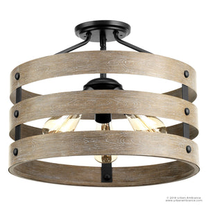 The Urban Ambiance UHP2470 Modern Farmhouse Flush-Mount Ceiling Fixture from the Adelaide Collection showcases three exposed bulbs within circular wooden bands, accented by a charcoal steel cage for an industrial flair. Measuring 13-1/2″ high by 17″ wide, this rustic ceiling light is an ideal choice for modern farmhouse décor.