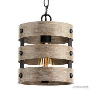 The UHP2472 Modern Farmhouse Pendant from the Adelaide Collection by Urban Ambiance features a cylindrical wood and metal frame with a charcoal finish, showcasing three horizontal wooden slats and an exposed central bulb. This rustic modern pendant light captures the open-cage aesthetic for an effortlessly stylish look. Dimensions: 10″H x 8-1/2″W.