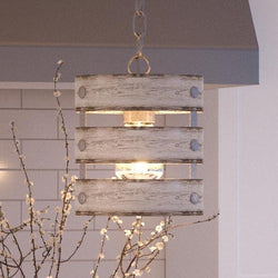 A unique UHP2473 Modern Farmhouse Pendant, 10"H x 8-1/2"W, Galvanized Steel Finish, from the Adelaide Collection hanging from a tree in a beautiful kitchen
