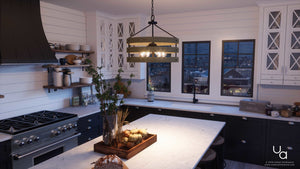 Modern kitchen with white shiplap walls, black cabinets, marble countertops, a gas stove, and a spacious central island illuminated by the Urban Ambiance UHP2474 Modern Farmhouse Chandelier from the Adelaide Collection (18-1/4″H x 21-5/8″W, Charcoal Finish). A cityscape is visible through the windows at dusk.