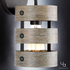 The UHP2480 Modern Farmhouse Bath / Wall Light from Urban Ambiance’s Adelaide Collection features a striking cylindrical design in wood and metal, with three horizontal wooden slats and an exposed bulb. Measuring 12 inches high by 6 inches wide in a Charcoal Finish, this wall-mounted fixture adds inviting farmhouse warmth to any bathroom or living space.