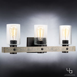 The Urban Ambiance UHP2484 Modern Farmhouse Bath Fixture from the Adelaide Collection features a charcoal-finished horizontal base with three clear textured glass shades and exposed filament bulbs, shown mounted against a gray gradient background—an elegant lighting choice that enhances rustic décor with its modern farmhouse style.