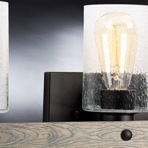 Close-up of the Urban Ambiance UHP2484 Modern Farmhouse Bath Fixture from the Adelaide Collection, featuring a clear glass shade, visible filament bulb, and a charcoal finish—an ideal addition to any modern farmhouse lighting ensemble.