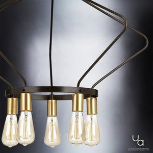 UHP2492 Mid-Century Modern Industrial Chandelier from the Palma Collection by Urban Ambiance features exposed Edison bulbs and a bold geometric design with an Olde Bronze metal frame and gold sockets, suspended against a gradient gray background. The Urban Ambiance logo appears in the bottom right corner.