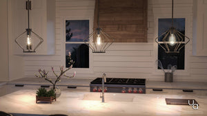 A kitchen with two gorgeous pendant lights hanging over a counter.