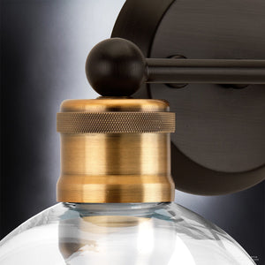 Close-up of the Urban Ambiance UHP2500 Vintage Industrial Bath Fixture from the Belfast Collection, showcasing its globe glass shade and Olde Bronze finish, set against a gradient background. This elegant 10-7/8″ high by 15-1/2″ wide wall-mounted light is perfect for adding sophistication to any space.