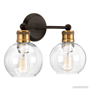 The Urban Ambiance UHP2500 Vintage Industrial Bath Fixture from the Belfast Collection features a wall-mounted design with two clear globe glass shades, exposed bulbs, and an elegant Olde Bronze finish accented by brass. Measuring 10-7/8″ high and 15-1/2″ wide, this fixture adds vintage-inspired style to any bath space.