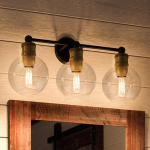 Three Urban Ambiance luxury lighting fixtures, 10-7/8"H x 24-1/2"W, hanging above a mirror in a bathroom.