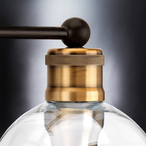 Close-up of the Urban Ambiance UHP2504 Vintage Industrial Bath Fixture from the Belfast Collection, featuring an Olde Bronze finish and globe glass design with a round rod attachment, showcased against a gradient gray background.