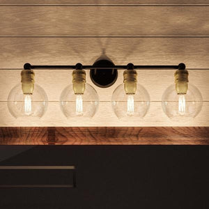 The Urban Ambiance UHP2504 Vintage Industrial Bath Fixture from the Belfast Collection features four clear, round glass globes with visible filaments, mounted horizontally on a sleek fixture finished in Olde Bronze. Measuring 10-7/8″ high by 33-1/2″ wide, this timeless design evokes vintage-inspired elegance and is beautifully complemented by wood-accented ceilings for a classic yet sophisticated look.