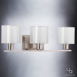 Three beautiful UHP2512 Cosmopolitan Bathroom Vanity Lights with white glass shades by Urban Ambiance.