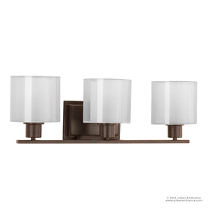 The Urban Ambiance UHP2513 Cosmopolitan Bathroom Vanity Light from the Tacoma Collection features an Olde Bronze finish with a square base and three evenly spaced cylindrical frosted glass shades on a horizontal bar, providing balanced illumination. Measuring 7.375″H x 23.5″W, this three-light fixture is ideal for contemporary bath spaces.