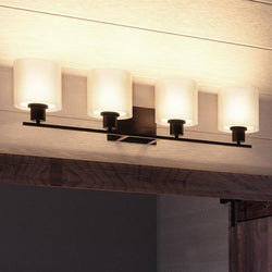 A luxury Urban Ambiance UHP2515 Cosmopolitan Bathroom Vanity Light with four gorgeous lights hanging from the ceiling.